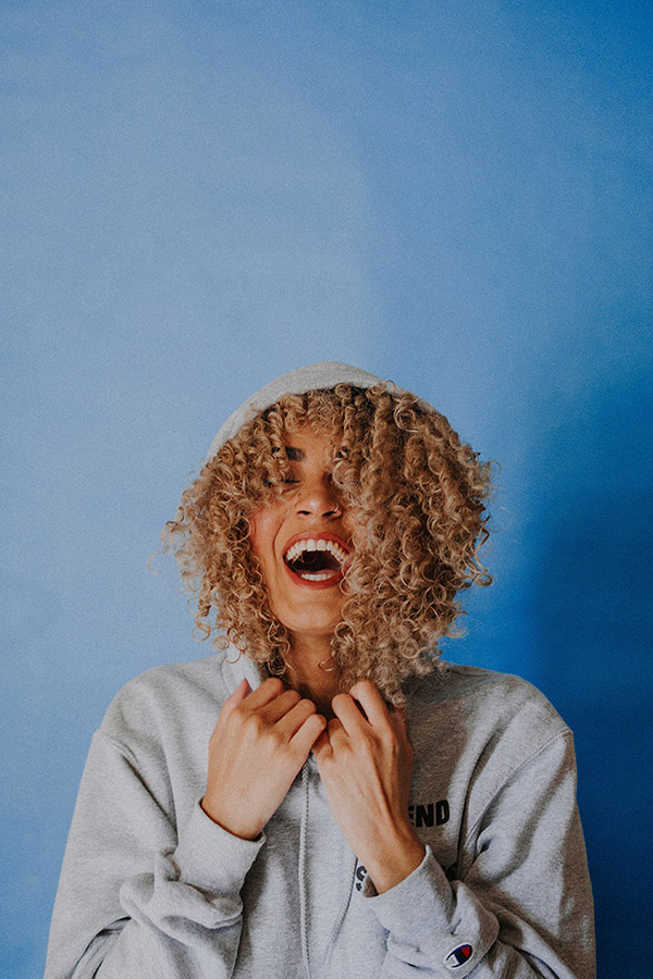 Girl smiling with blue background